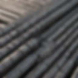 Close-up view of various types of steel reinforcement bars showcasing their textures and finishes.